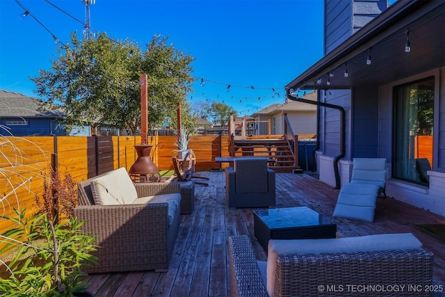 wooden terrace featuring an outdoor living space