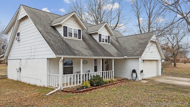 cape cod-style house with a porch, a garage, and a front yard