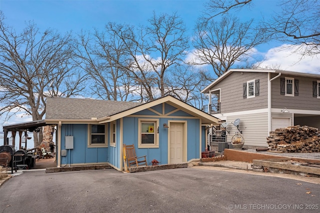 view of front of house with central AC unit and a garage