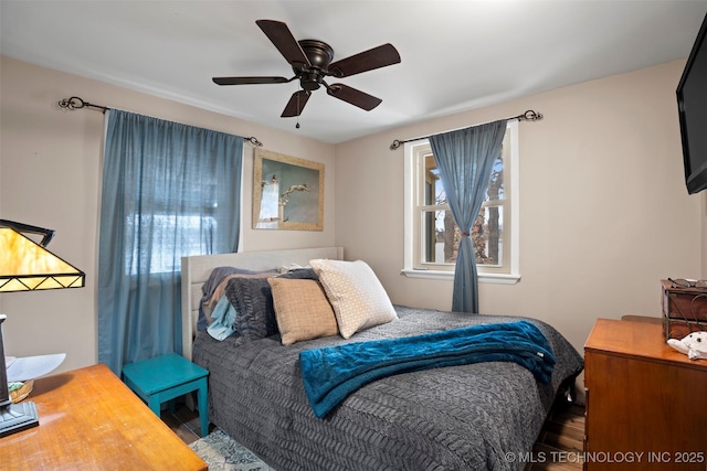 bedroom with wood-type flooring and ceiling fan