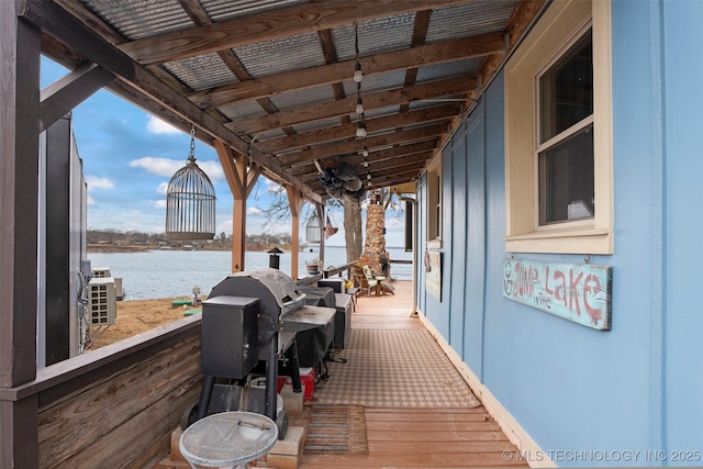 deck featuring area for grilling and a water view