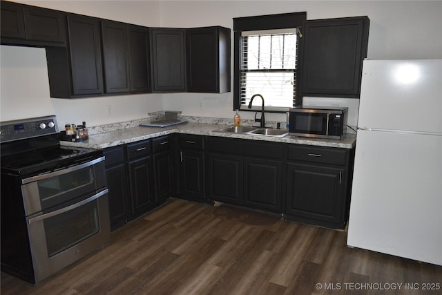 kitchen featuring stainless steel appliances, dark hardwood / wood-style floors, and sink