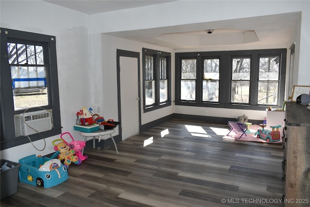 game room with cooling unit, dark hardwood / wood-style flooring, and a raised ceiling