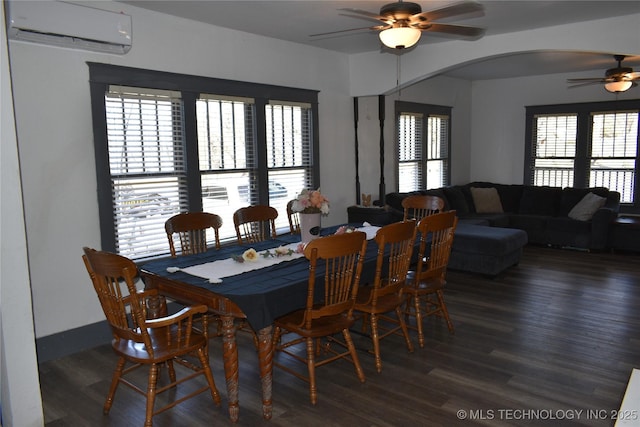 dining space with a wall mounted air conditioner, dark hardwood / wood-style floors, and ceiling fan