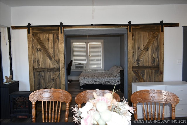 interior space with a barn door and hardwood / wood-style floors