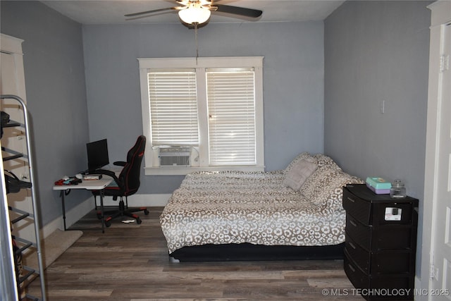 bedroom featuring cooling unit, ceiling fan, and dark hardwood / wood-style flooring