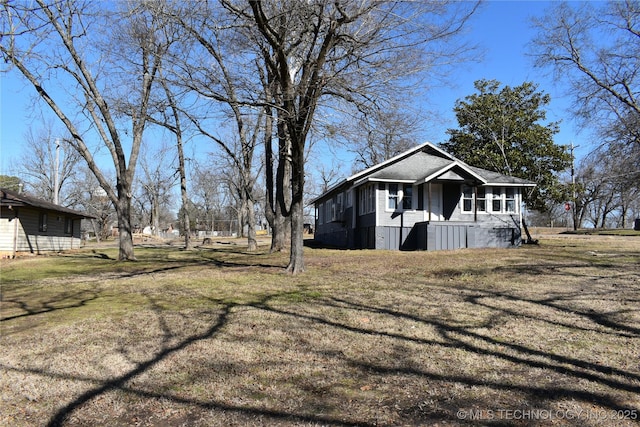 view of property exterior with a lawn