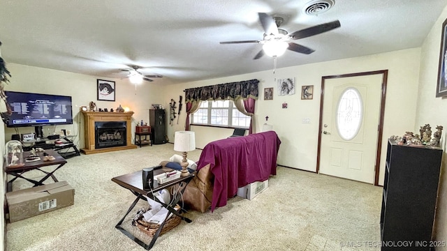 96848 S 4510th Rd, Vian, OK 74962 - carpeted living room featuring ceiling fan, a fireplace with raised hearth, and a textured ceiling