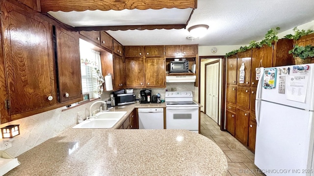 96848 S 4510th Rd, Vian, OK 74962 - kitchen with white appliances, a sink, light countertops, brown cabinets, and tasteful backsplash