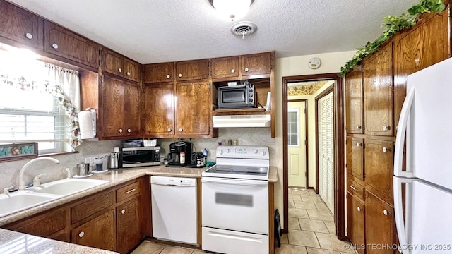 96848 S 4510th Rd, Vian, OK 74962 - kitchen featuring white appliances, under cabinet range hood, brown cabinetry, backsplash, and a textured ceiling