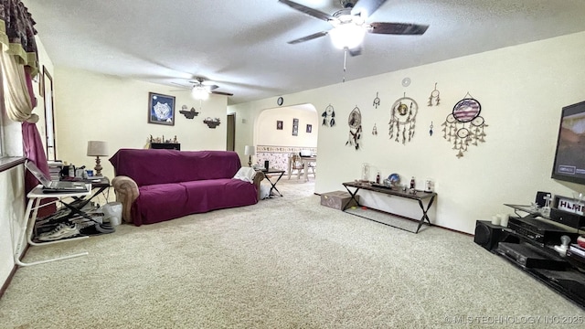 96848 S 4510th Rd, Vian, OK 74962 - carpeted living room with ceiling fan and arched walkways