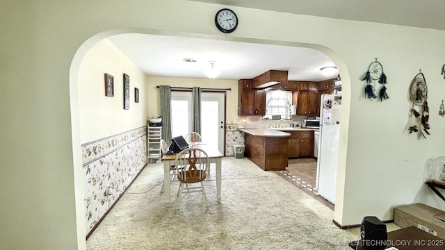 96848 S 4510th Rd, Vian, OK 74962 - kitchen featuring arched walkways, light countertops, light carpet, a sink, and freestanding refrigerator