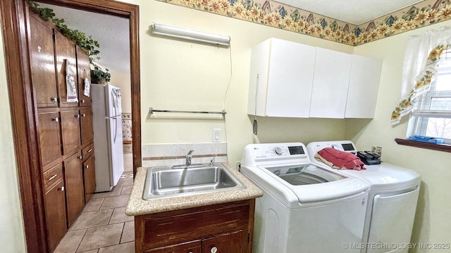 96848 S 4510th Rd, Vian, OK 74962 - laundry room featuring washer and dryer, cabinet space, and light tile patterned floors