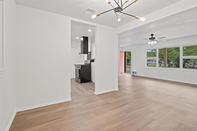 501 W 17th St, Pawhuska, OK 74056 - unfurnished living room with light wood finished floors, a ceiling fan, baseboards, a chandelier, and recessed lighting