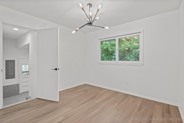 501 W 17th St, Pawhuska, OK 74056 - empty room featuring electric panel, a chandelier, wood finished floors, baseboards, and recessed lighting