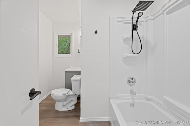 501 W 17th St, Pawhuska, OK 74056 - bathroom featuring toilet, wood finished floors, bathing tub / shower combination, and baseboards