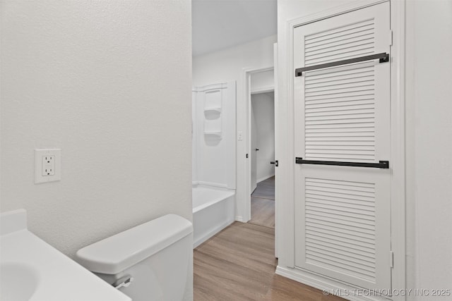 501 W 17th St, Pawhuska, OK 74056 - full bathroom with toilet, wood finished floors, vanity, and shower / washtub combination