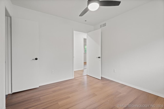 501 W 17th St, Pawhuska, OK 74056 - unfurnished room with wood finished floors, ceiling fan, and baseboards