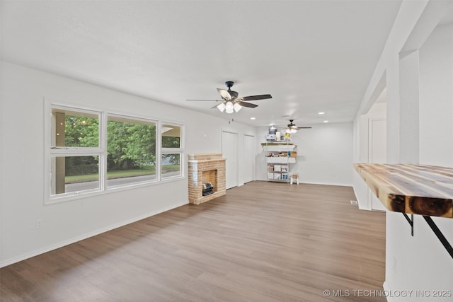 501 W 17th St, Pawhuska, OK 74056 - living room featuring a fireplace, light wood-style floors, baseboards, and recessed lighting