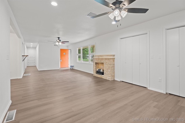 501 W 17th St, Pawhuska, OK 74056 - unfurnished living room featuring a ceiling fan, light wood-style flooring, a fireplace, baseboards, and recessed lighting
