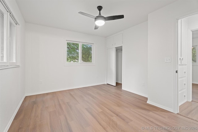 501 W 17th St, Pawhuska, OK 74056 - unfurnished bedroom featuring light wood-style floors, baseboards, a closet, and a ceiling fan