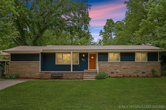 501 W 17th St, Pawhuska, OK 74056 - view of front facade with a front yard, stone siding, and crawl space