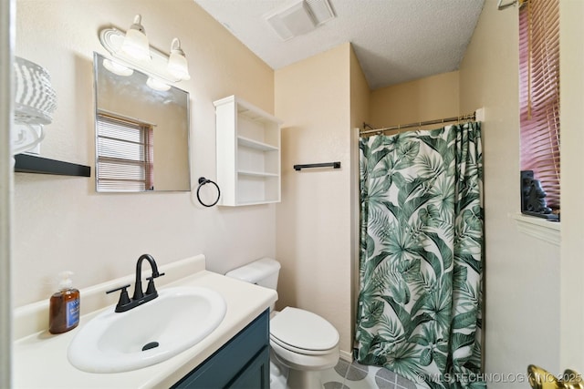 bathroom featuring vanity, toilet, curtained shower, and a textured ceiling