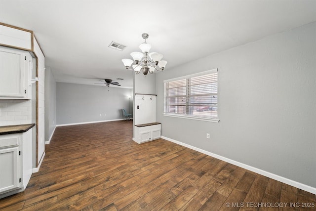 kitchen featuring white cabinetry, ceiling fan with notable chandelier, dark hardwood / wood-style flooring, and tasteful backsplash