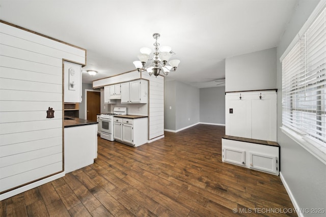 kitchen with gas range gas stove, white cabinetry, an inviting chandelier, dark hardwood / wood-style floors, and decorative light fixtures