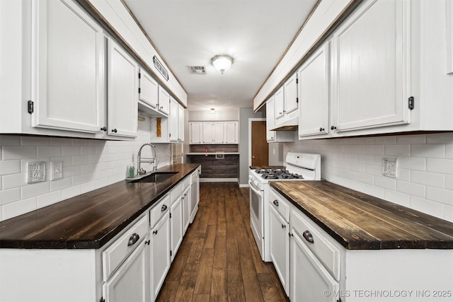 kitchen featuring sink, white appliances, dark hardwood / wood-style floors, white cabinets, and decorative backsplash