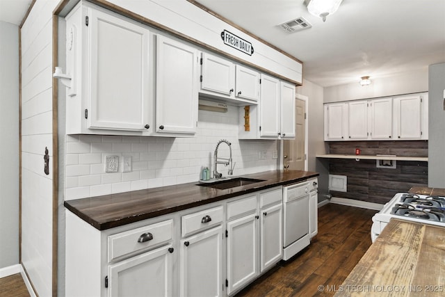 kitchen with sink, dark wood-type flooring, white cabinets, and white appliances