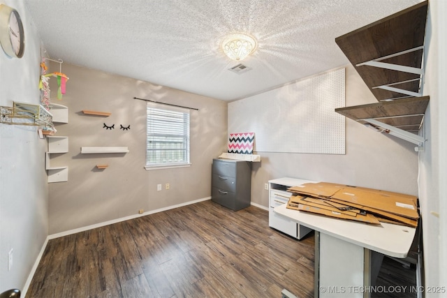 miscellaneous room with dark hardwood / wood-style floors and a textured ceiling