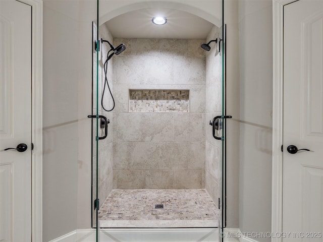 bathroom featuring a shower with shower door