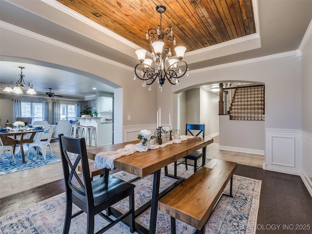 dining room with crown molding, a tray ceiling, and wooden ceiling