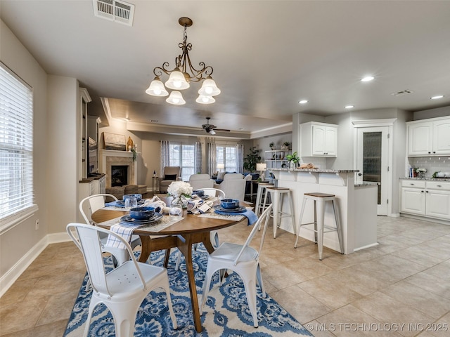 dining area with light tile patterned flooring and ceiling fan