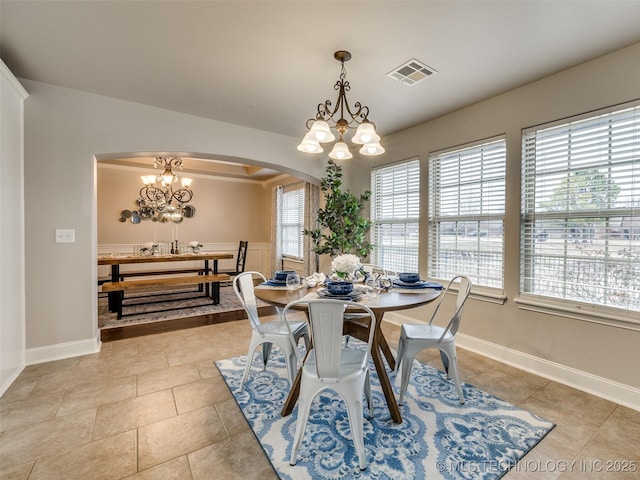 dining space with light tile patterned floors and a notable chandelier