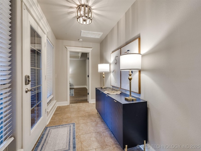 interior space featuring light tile patterned floors, french doors, and a chandelier