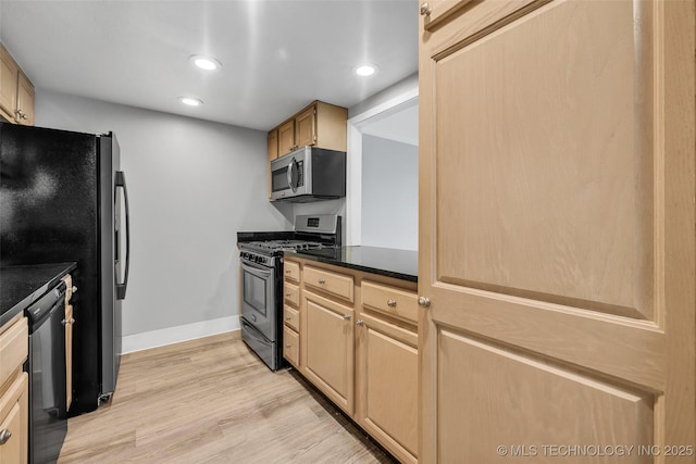 kitchen with stainless steel appliances, light hardwood / wood-style floors, and light brown cabinets