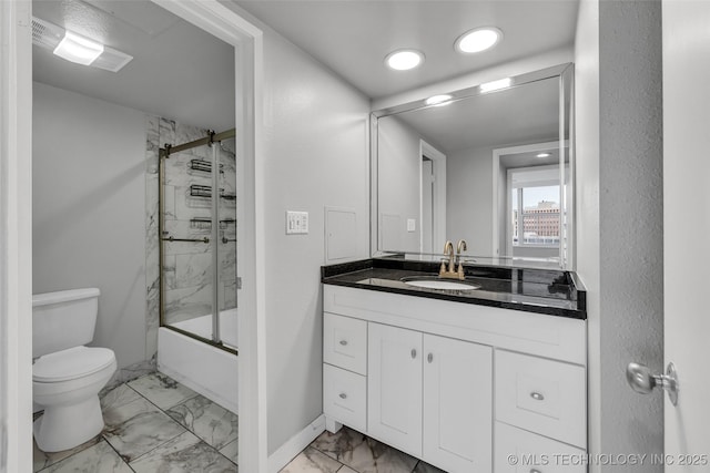 full bathroom with vanity, combined bath / shower with glass door, and toilet