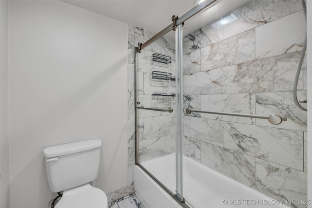 bathroom with toilet and combined bath / shower with glass door