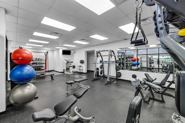 workout area featuring a paneled ceiling