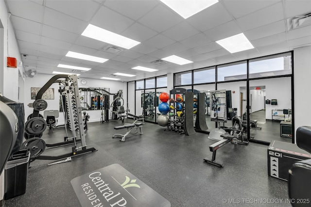 gym with a paneled ceiling