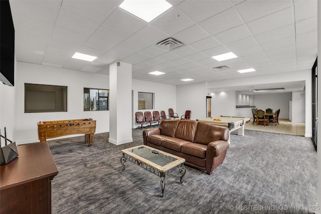 carpeted living room with a paneled ceiling