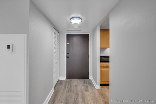 hall with light hardwood / wood-style flooring