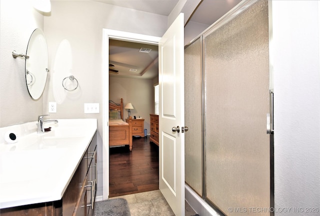 bathroom with walk in shower and vanity