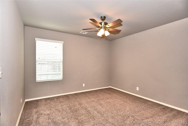 carpeted spare room with ceiling fan