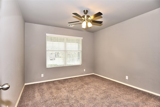 carpeted spare room with ceiling fan