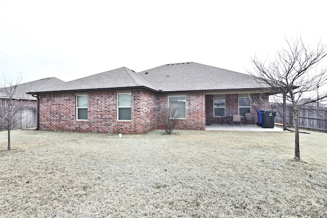 rear view of house featuring a yard and a patio area