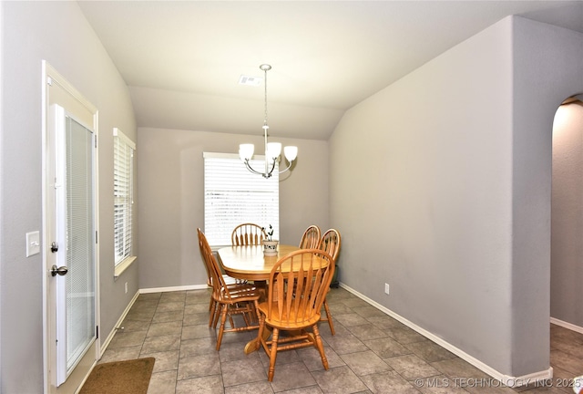 dining room with vaulted ceiling and a notable chandelier