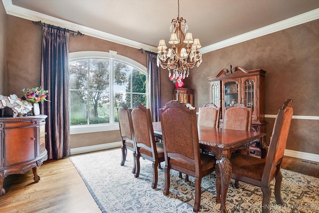 6215 E 86th Pl, Tulsa, OK 74137 - dining area with crown molding, light hardwood / wood-style floors, and a chandelier